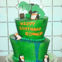 Penguins Of Madagascar 2 tier topsy turvy iced in bc. fondant hand made penguins, piping gel water