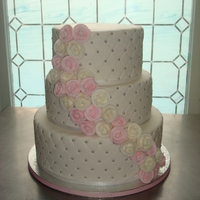 Quilted Cake With Pink And White Royal Flower Cascade this is a 12-10-8 in round wedding cake. All white cake with 2 layers of vanilla filling and middle layer with strawberry cream filling....