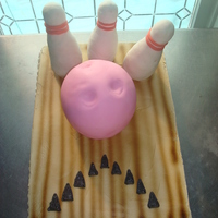 3D Bowling Cake this was a marble cake with a white bowling ball. 1/2 sheet cake, wilton ball pan and rice cereal pins. Lanes are bc airbrushed and ball...
