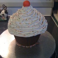 Birthday Cupcake! I used the Wilton Giant Cupcake Pan and had butter pecan cake on top and chocolate on bottom. Frosting is buttercream. Cherry is fondant.