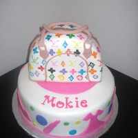 The Louis Vutton Fashionista Cake First cake of this kind. It wasn't as easy as I thought, but I learned alot. Purse on top is cake also.