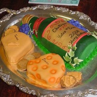 Wine N Cheese Bottle and cheese are cake covered with fondant, the bottles is acceted with gumpast leaves. The crackers are cookies