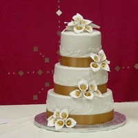Golden Splendor Buttercreme iced cake with handmade calla-lilies dusted with gold luster dust.