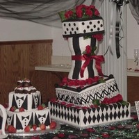Just For The Bride Brides cake was 5ft covered wih fondant accented with pearls, piping and roses.Grooms cake was buttercreme with fondant accents topped with...