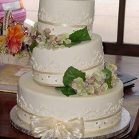 Whimsical Fondant covered with flowers and cloth ribbon