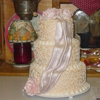 Drapes And Flowers Buttercreme with fondant drape and handmade gumpaste flowers.