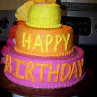 Gracy's Birthday Luau Cake three tier- all yellow cake 2 layers per tier- buttercream icing and fake hibiscus flowers down one side.