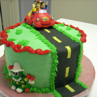 Wiggles Yellow WASC with Raspberry White Chocolate Ganache filling and BC frosting.