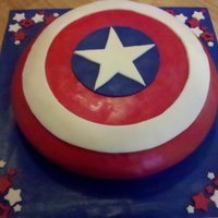 Captain America's Shield For a 12 year boy who loves Captain America. This was made from a 16" cake. Bottom layer was pound cake, top was strawberry. All...