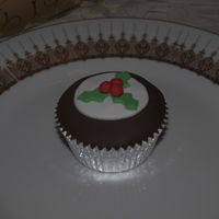 Christmas Pudding Cupcake A chocolate cupcake filled with white choc brandy sauce iced with fondant decorations.