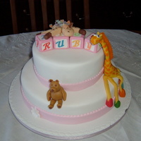 Ruby's Christening Cake - My Granddaughter Fruit cake covered with marzipan and sugarpaste. Ruby's mother wanted her favourite toys modelled and put on the cake. These are made...