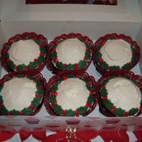 Christmas Wreath Cupcakes Devils Foodcake cupcakes with a fresh strawberry inside. Covered with whipped fresh cream and marzipan holly leaves and berries.