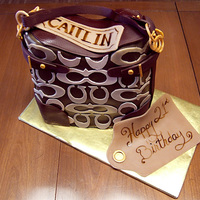 Caitlin's Coach Vanilla Poundcake with Midnight Ganache filling. Cloth on the bag is fondant, leather is chocolate plastic (modelling chocolate), Coach C&#...