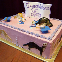 Grad Cake With Ferret Motif White Vanilla Cake with Raspberry Italian Meringue Buttercream with graduation, vet (stethoscope), and ferret motif. First time making...
