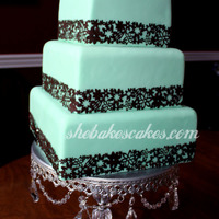 Aqua And Brown Wedding Cake 6", 8" & 10" squares. Mermaid green (greenish blue) with brown floral boarder. This cake is incredibly difficult to...