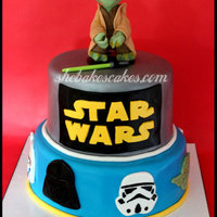 Star Wars Cake 2 tier Star Wars themed cake. 3D sculpted Yoda on top! Various faces/masks surround the bottom tier including Darth Vader, Clone Tooper,...