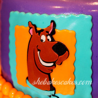 Scooby Doo Birthday Cake 2 tier Scooby Doo cake. Colorful Scooby plaques surround the bottom tier, and a 3D Scooby Doo collar tops it off. This was for a little boy...