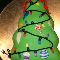 Christmas Tree, Unplugged ;) 2 layer dark chocolate fudge cake, chocolate BC, covered in vanilla fondant. Ribbon, lights, ornaments & cord/plug are all fondant....