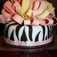 Alaina's Birthday Cake This is a birthday cake I made for my daughter's friend. She was turning 19!. LOVED it. I made the ribbon bits from 1/2 fondant and 1/...