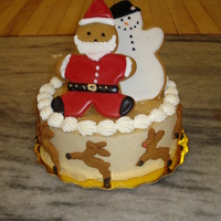 Chrismas Cookie Cake Hand decorated gingerbread men on a Eggnog mousse cake.