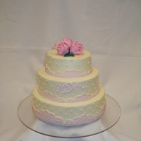 Wedding Cake Fondant lace border around a light yellow butter cream with marzipan roses.