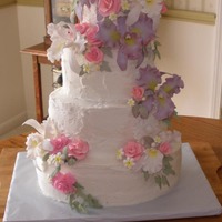 Tim & Angel's Wedding Four tier oval wedding cake with stucco finish; gum paste orchids and roses in purple, white and pink. I made this wedding cake for one of...