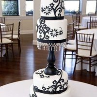 Round Wedding Cake With Fondant & Gumpaste I made this cake for one of my best friends wedding. It is a four tier cake with a candlestick holder as a separator. The flowers and 3-...