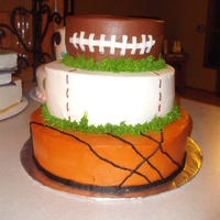 Sports Cake This cake was done for a baby shower for two ladies who were both having boys. The bottom two tiers are covered in vanilla buttercream and...