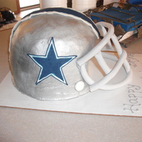 Dallas Cowboys Helmet Made using two 9"round cake pans and a dome pan. Frosted with buttercream. Grill is made half mmf, half gumpaste.
