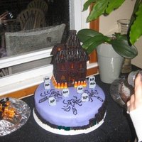 Halloween Party Cake was chocolate and vanilla layers, filled with frosting dyed the same color as the outside, house is chocolate cookie, w/melted...