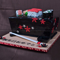 Sushi Revisited 12"-10" Tapered Rectangle, White Chocolate Cake with Raspberry SMBC, Black Satin Ice Fondant, Sushi pieces are cake with fondant...