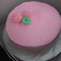 Strawberry Pink Cake Strawberry Cake with Pink and White buttercream, with soft pink fondant rose accents.