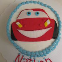 Disney Cars Lightning Mcqueen Smash Cake 4" round vanilla/vanilla buttercream cake. Car was freehanded on paper, then cut out to use as a template to cut fondant. Some details...