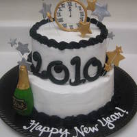 New Year's Celebration Cake 2 tier white almond cake with bavarian creme flavored buttercream, 6" on top of 8". All decorations are fondant. Champange bottle...