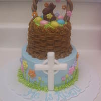 Easter Cake Mini 2-tier (4" on top of a 6") orange cake with raspberry buttercream filling. All buttercream icing with fondant basket handle...