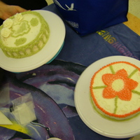 Wilton Course 1 These are the first cakes my wife and I made for the Wilton Course 1 class. Hers is the one in front, mine is the one in back. It's...