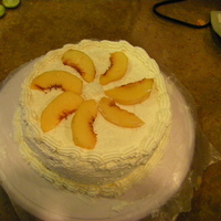 Almond Genoise Almond Genoise cake with a whipped cream and glazed peach filling. The remaining peaches were used as garnish on top.