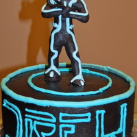 Tron Legacy Tron Legacy cake for a boy who also plays lacross. He's holding a lacross stick.