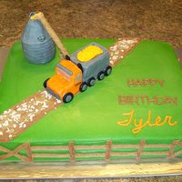Semi-Truck And Grain Bin Birthday Cake 11x15 chocolate cake, done in buttercream. The truck and grain bin are done with rkt, and covered in fondant