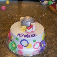 Rollerskating Bday Buttercream with fondant accents. !st time doing flowers & My first time with the wire. I think I would do those differently. But,...