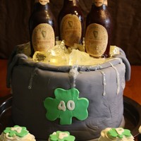 Beer Bucket Cake Sugar bottles with rice paper. Isomalt cubes. 4 layer of cake covered in fondant. My first beer cake.