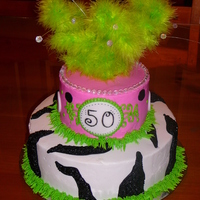 Funky Zebra This is a 10 and 8 in round with buttercream base icing. Fondant dots and feathers and bead sprays on top.