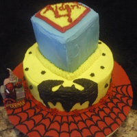 Superhero Cake Two tiered buttercreme frosted WASC. Spiderman bottom cake board, frosted and piped with webbing detail. Center cake Batman, freehanded...