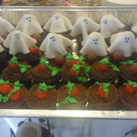Ghosts In A Pumpkin Patch Devil's food cupcakes with MMF ghost toppers and mallow pumpkins. For a large Halloween Party.