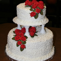 First Wedding Cake Top layer is a double 6 inch and bottom is a double 10 inch. The roses are made out of royal icing.