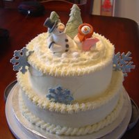 Christmas Baby Shower Cake 2 layer butter yellow cake with cream cheese icing, color flow snowflakes, and gum paste topper