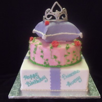 Princess Cake Yellow Butter Small pillow cake and 10'' Chocolate Round Cake. Sitting on 12'' sqaure dummy. Tiara/crown is gumpaste.