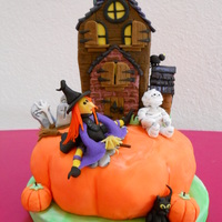 Happy Halloween Pumpkin is a carrot cake with cream cheese icing covered with orange fondant. The figures in this cake are made from fondant and the...