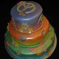 Rainbow Peace Flower Happy Face Air Brushed My first time using my air brush. Turned out good except for the top tier I sprayed too thick, so the fondant slid down the sides.....