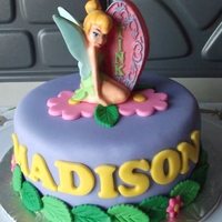 Tinkerbell Cake This is a 6x3 inch chocolate cake covered in fondant and fondant accents. It's topped with a Tink candle...there will also be 30...